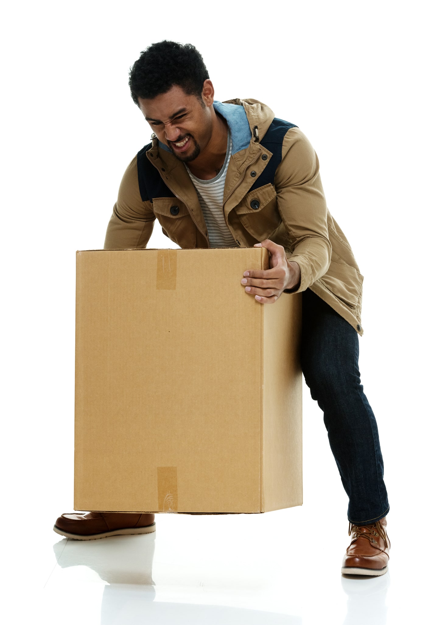 A man picking up a very heavy box struggling.