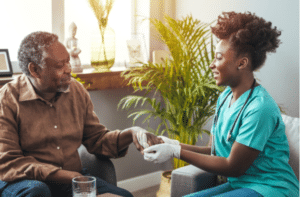 Female carer holding hands of senior man