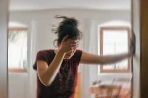 Blured photo of a woman suffering from vertigo or dizziness or other health problem