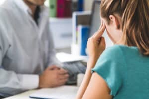 Woman consulting with neurosurgeon about brain tumor in Dallas, TX