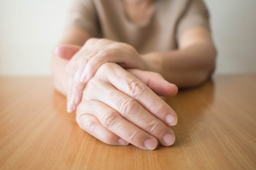 Close up of a person's hands stopping tremors from Parkinson's Disease in Dallas, TX